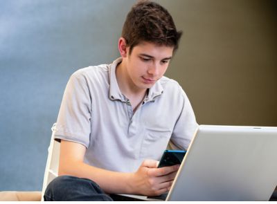 Image of a teenager using a laptop or smartphone, symbolizing the potential of online earnings